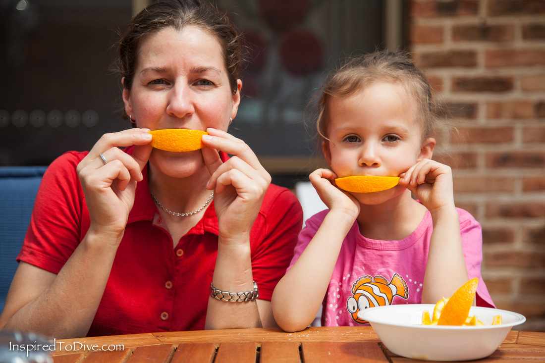 Underwater photographer Alison Perkins eating oranges with her niece Sophie