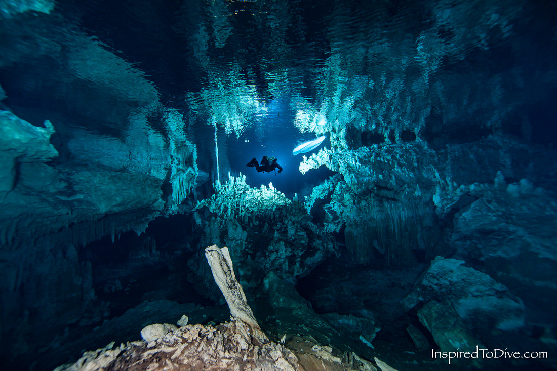 Cave diver with kayak in cenote Nohoch Nah Chich in Mexico