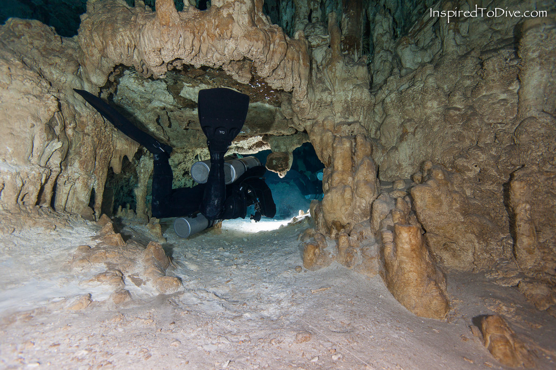 A cave diver passes through a restriction