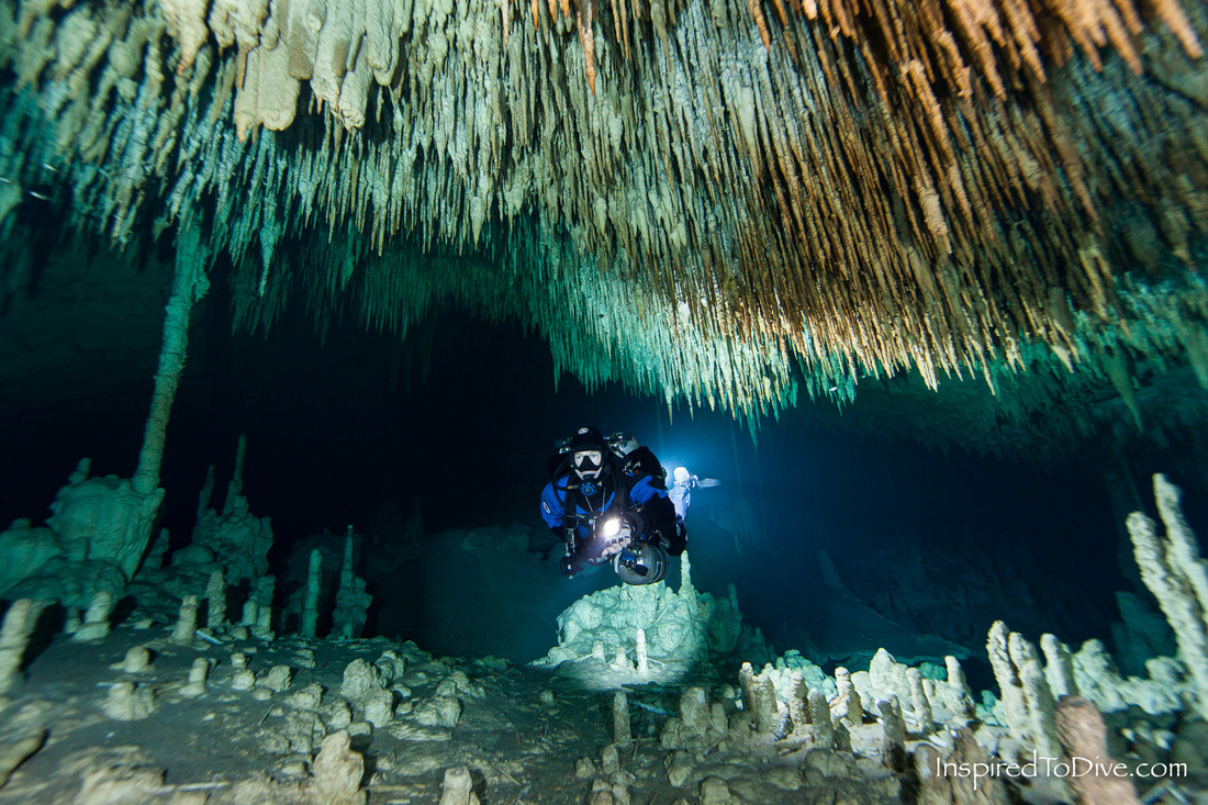 Cave diver with underwater stalactites in cave system Sac Actun in Mexico